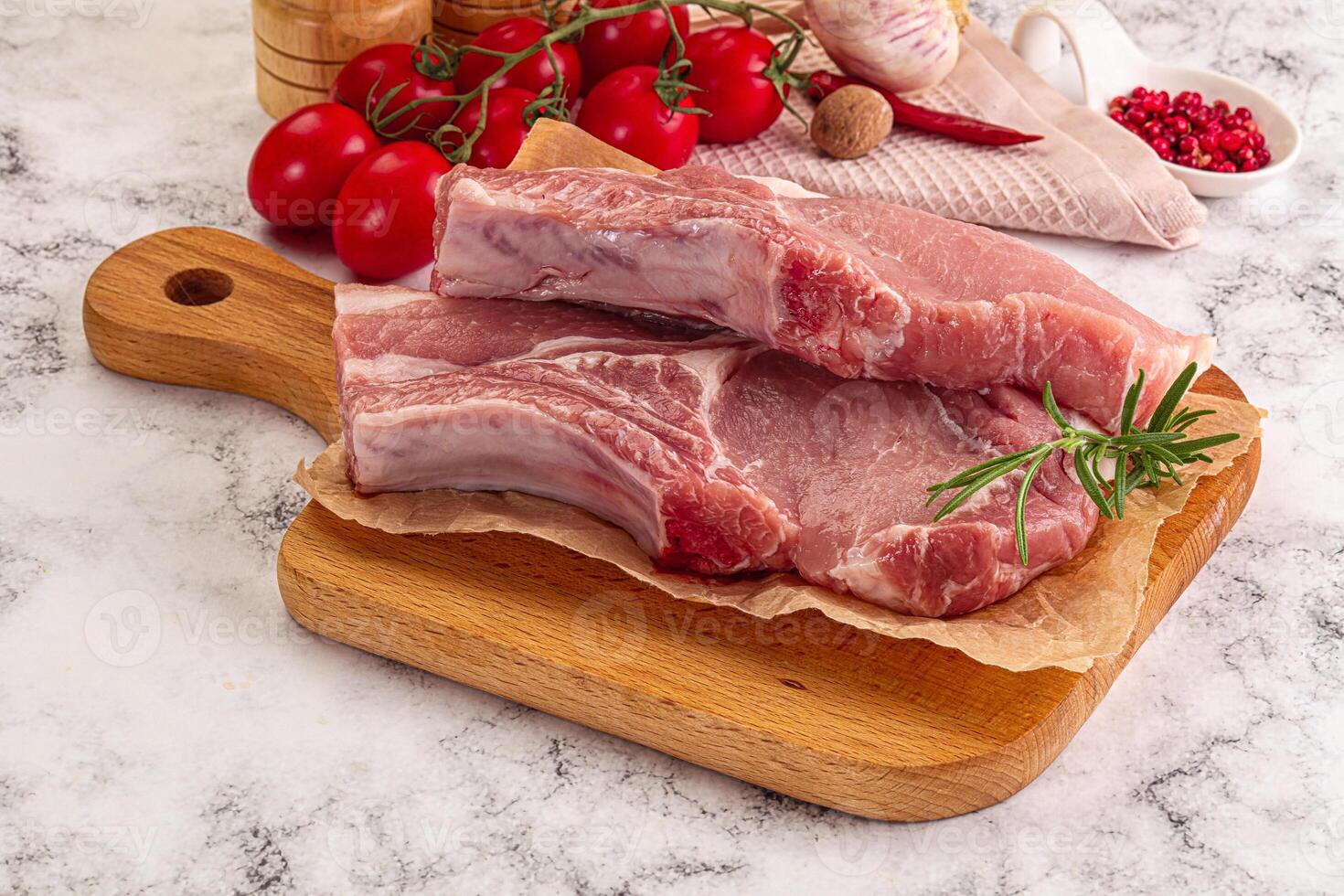 A wooden cutting board with two pieces of meat on it photo