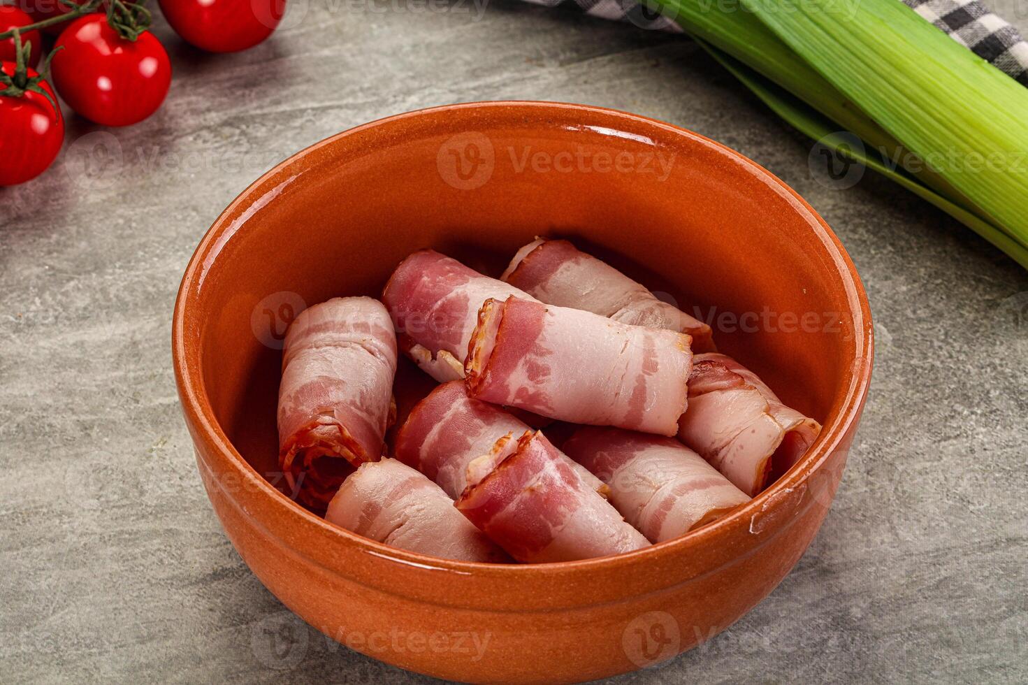 A bowl filled with bacon and vegetables photo