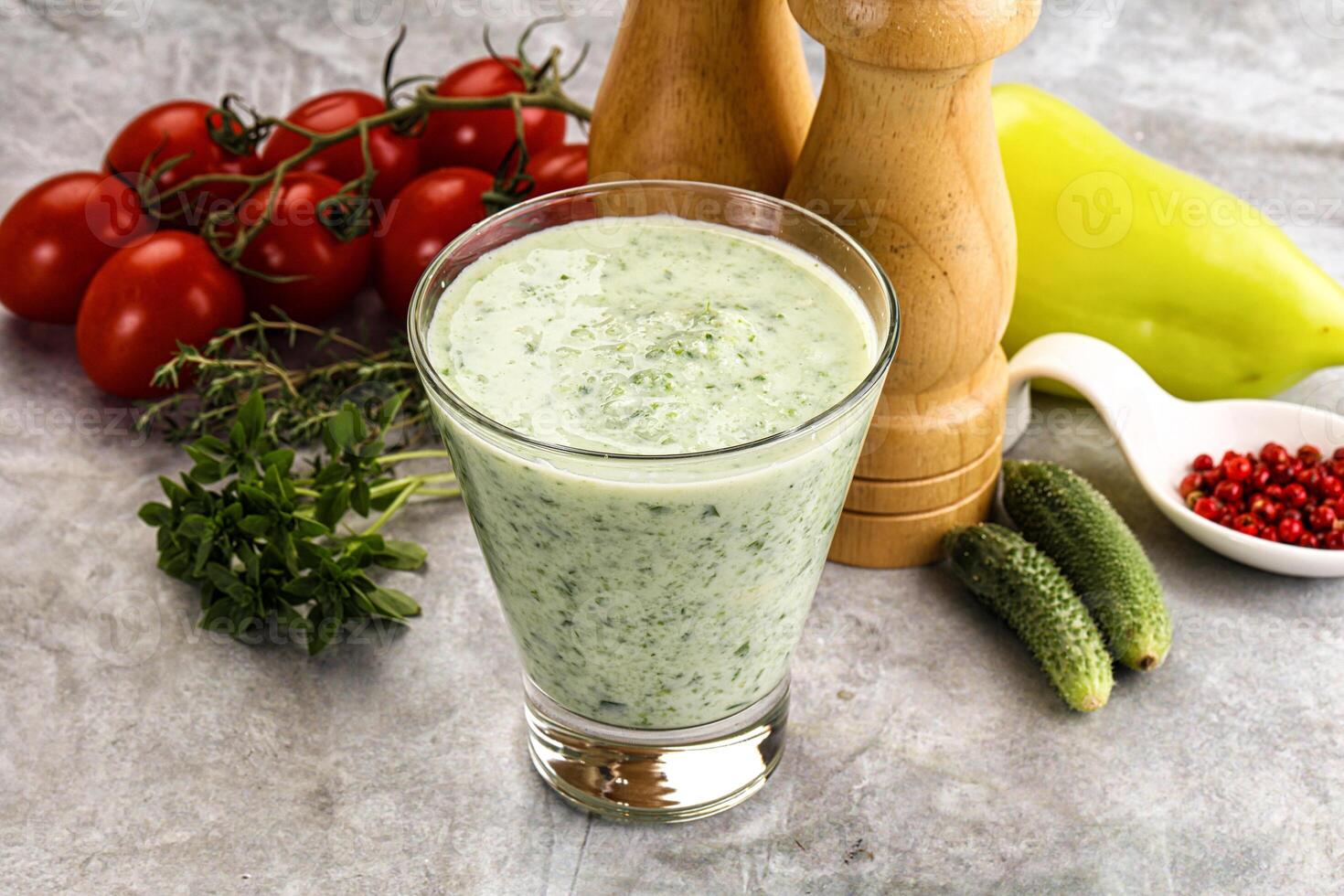 A glass of green smoothie with tomatoes and peppers photo