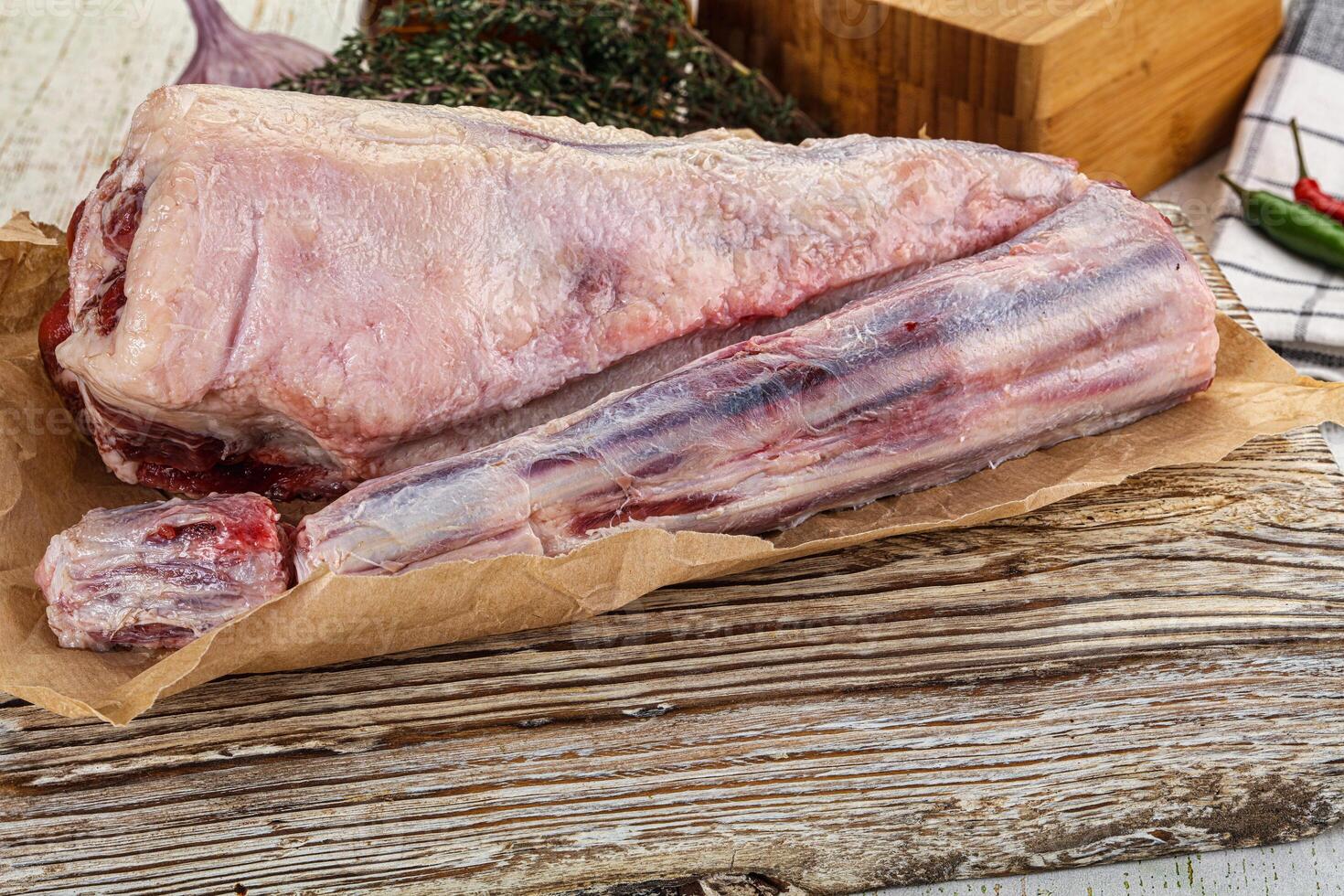 A piece of meat on a wooden table photo