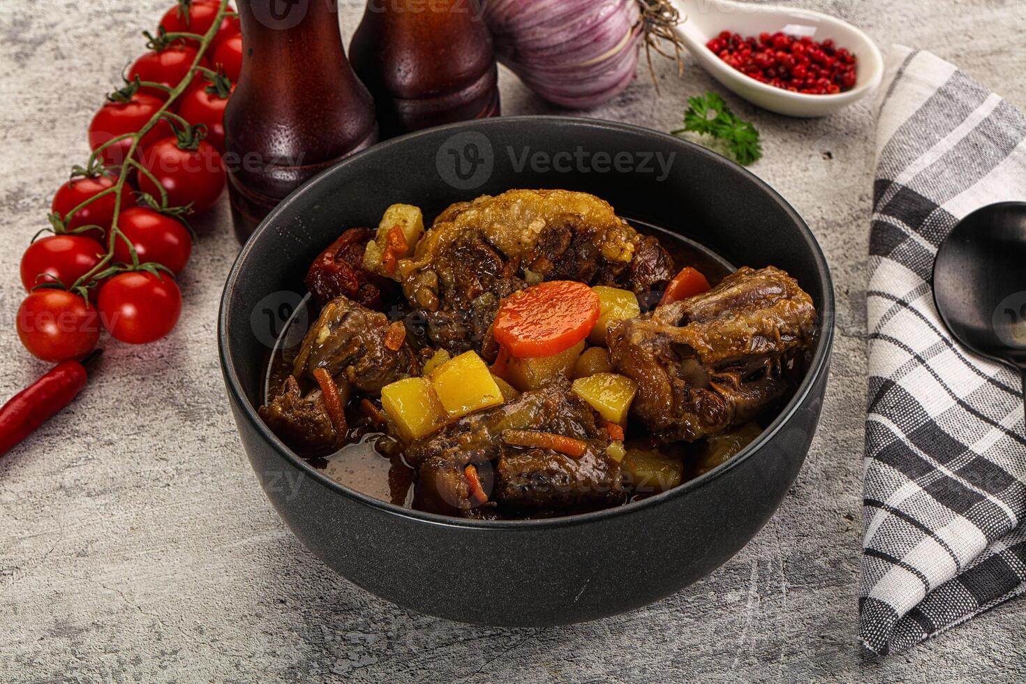 A bowl of stew with vegetables and meat in it photo