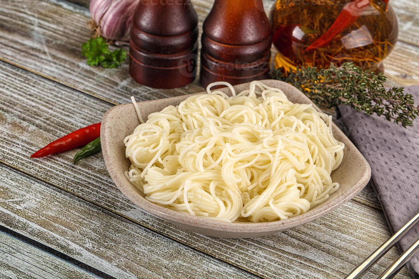 Chopsticks and noodles on a wooden table photo