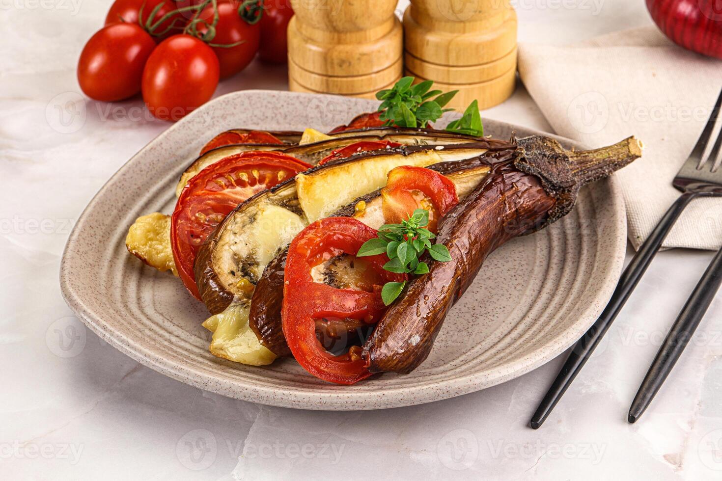 A plate with a steak, vegetables and a knife and fork photo
