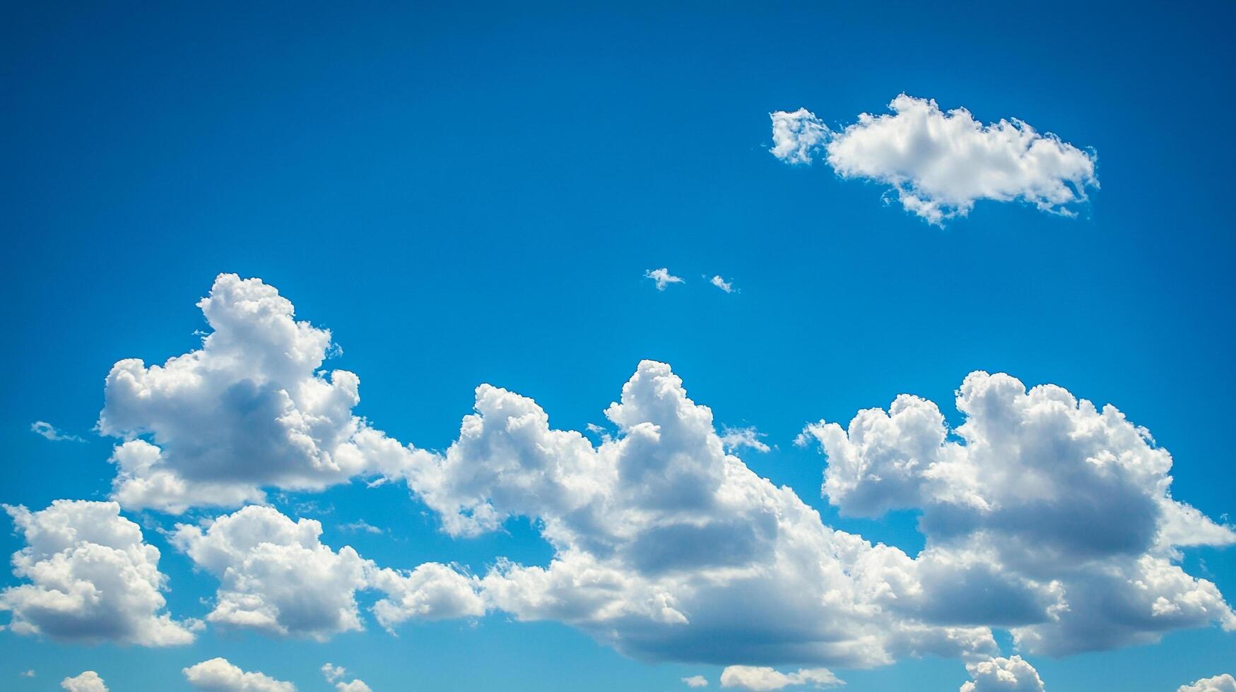 Bright blue sky dotted with fluffy white cumulus clouds. Natural beauty on a sunny day, capturing peaceful atmosphere of weather. photo