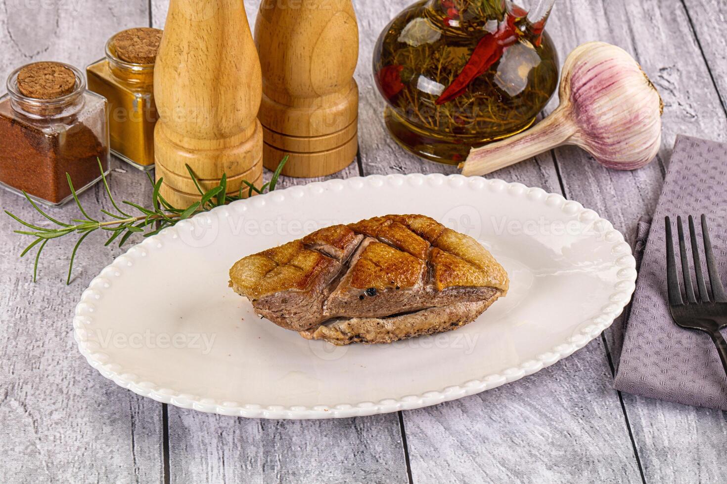 A plate of food on a table with a knife and fork photo