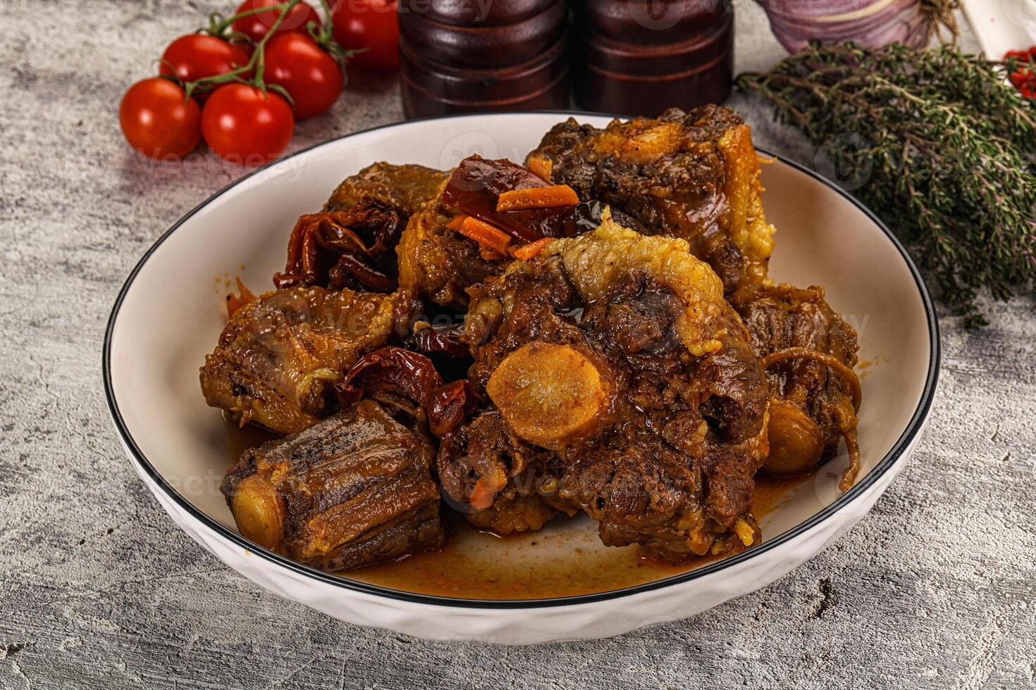 A bowl of meat and vegetables on a table photo