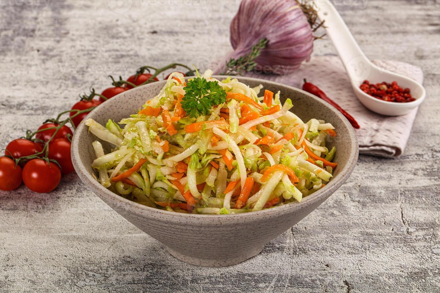 A bowl of coleslaw with carrots and onions photo