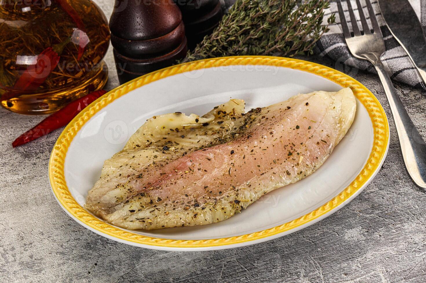A plate of fish with a knife and fork on a table photo