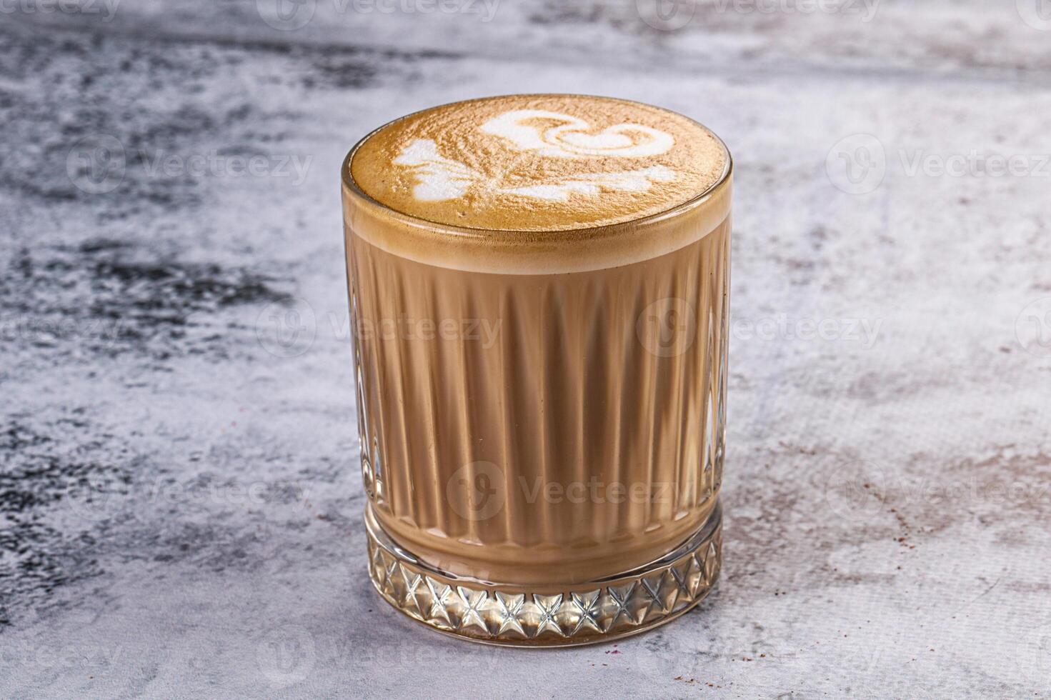A latte with a heart design on top photo