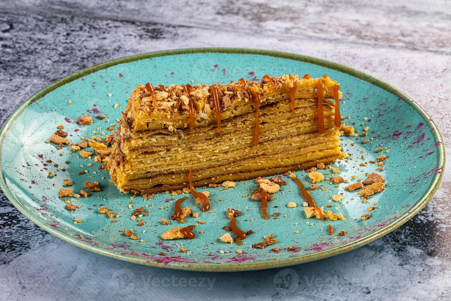 A piece of cake on a plate with nuts on it photo