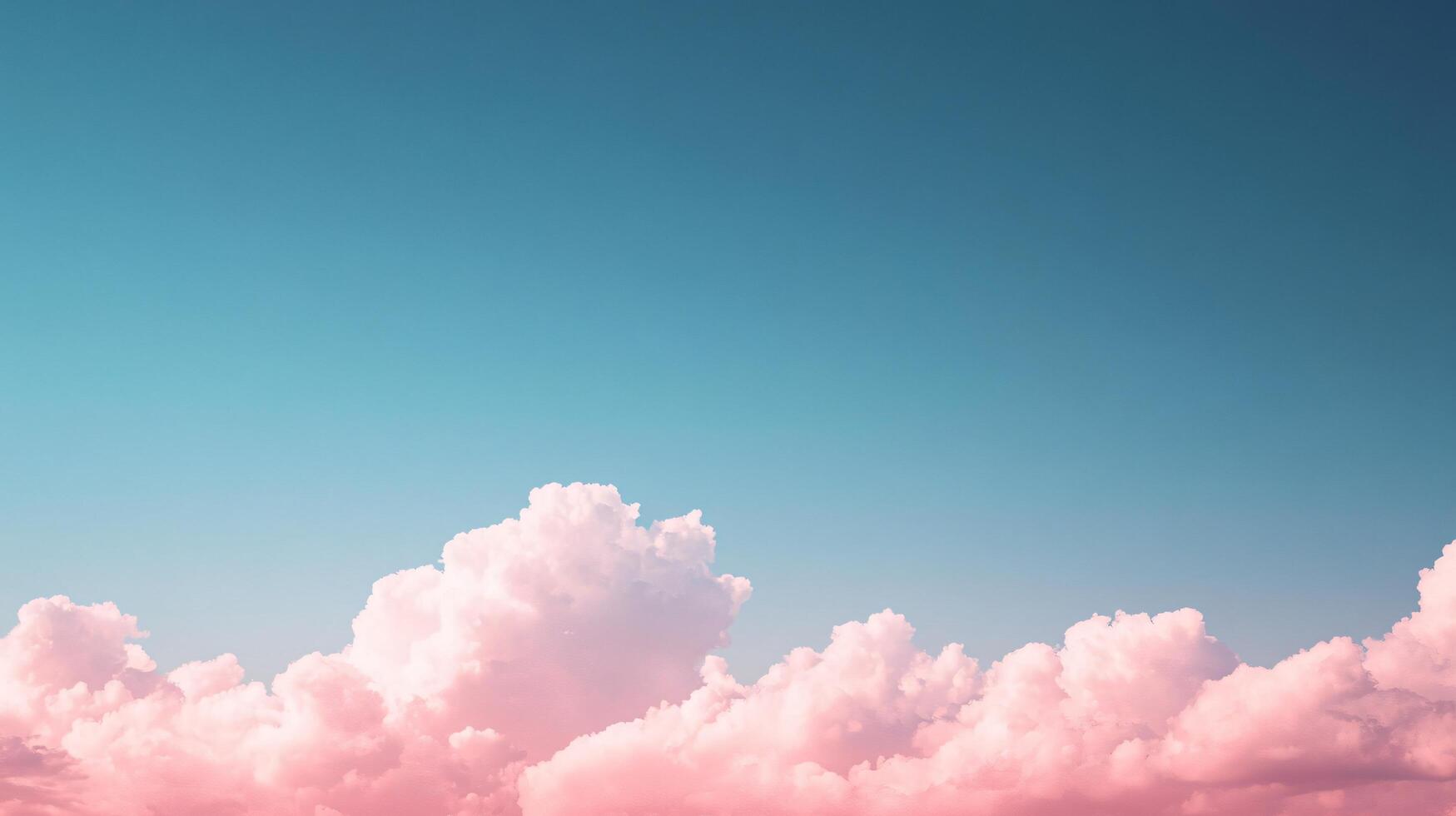 Pink clouds float across a teal blue sky, creating a serene and dreamy atmosphere photo