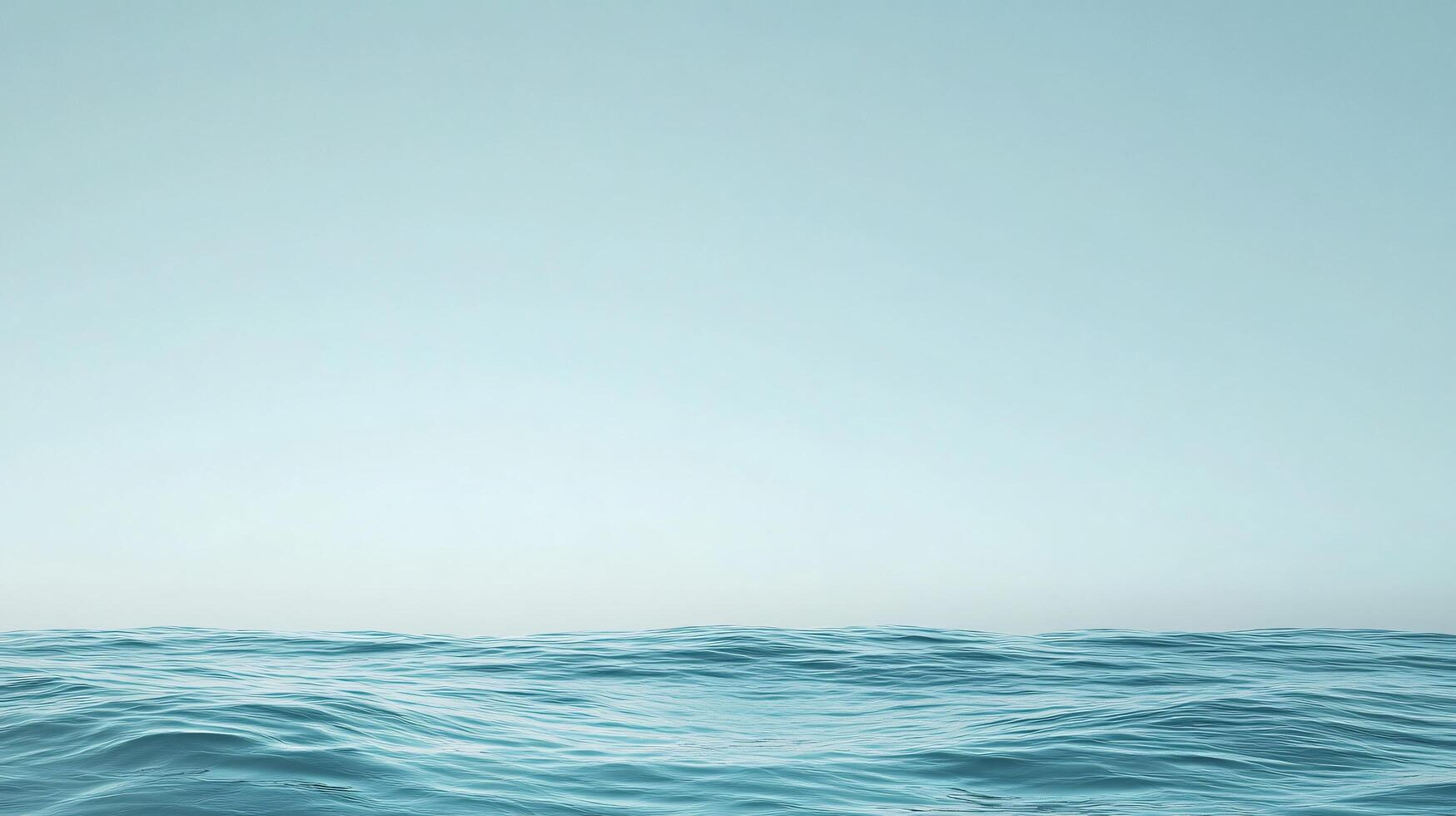 Blue ocean with no land in the background. The water is calm and peaceful. The sky is clear and bright, with no clouds in sight. The scene is serene and tranquil, with the ocean as the main focus photo