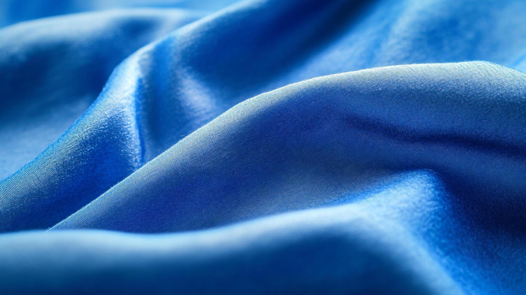 Luxurious blue silk fabric flowing and creating soft waves, perfect for backgrounds or design elements photo