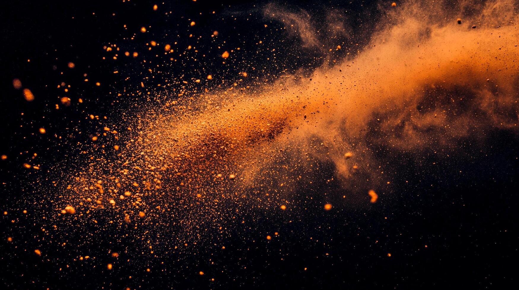 Abstract image of powder explosion, with golden dust particles in motion against a dark background, creating a dynamic visual display. photo