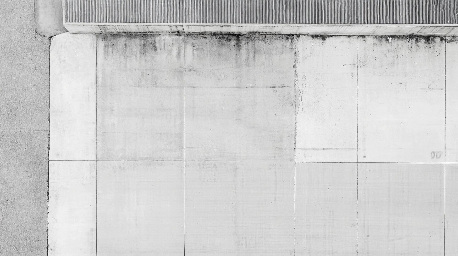 Minimalist concrete wall with geometric patterns and subtle textures, creating an abstract and architectural composition. photo