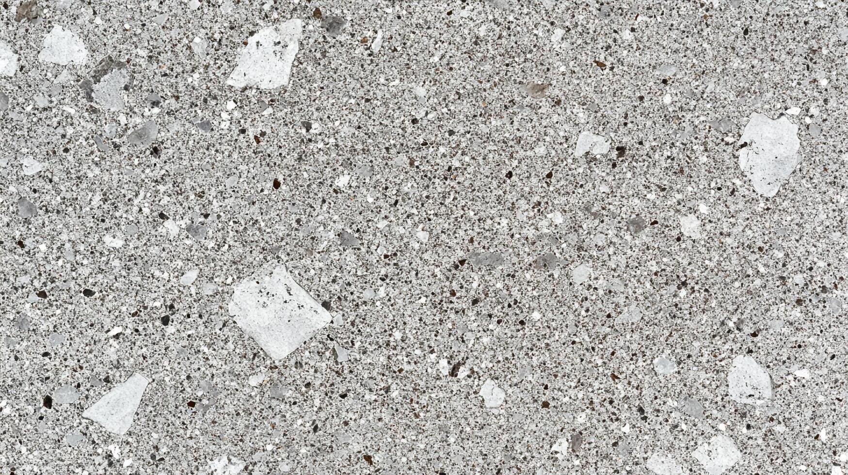 Detailed grey terrazzo stone with a mix of speckles and larger fragments, creating a textured surface for flooring or countertops. photo