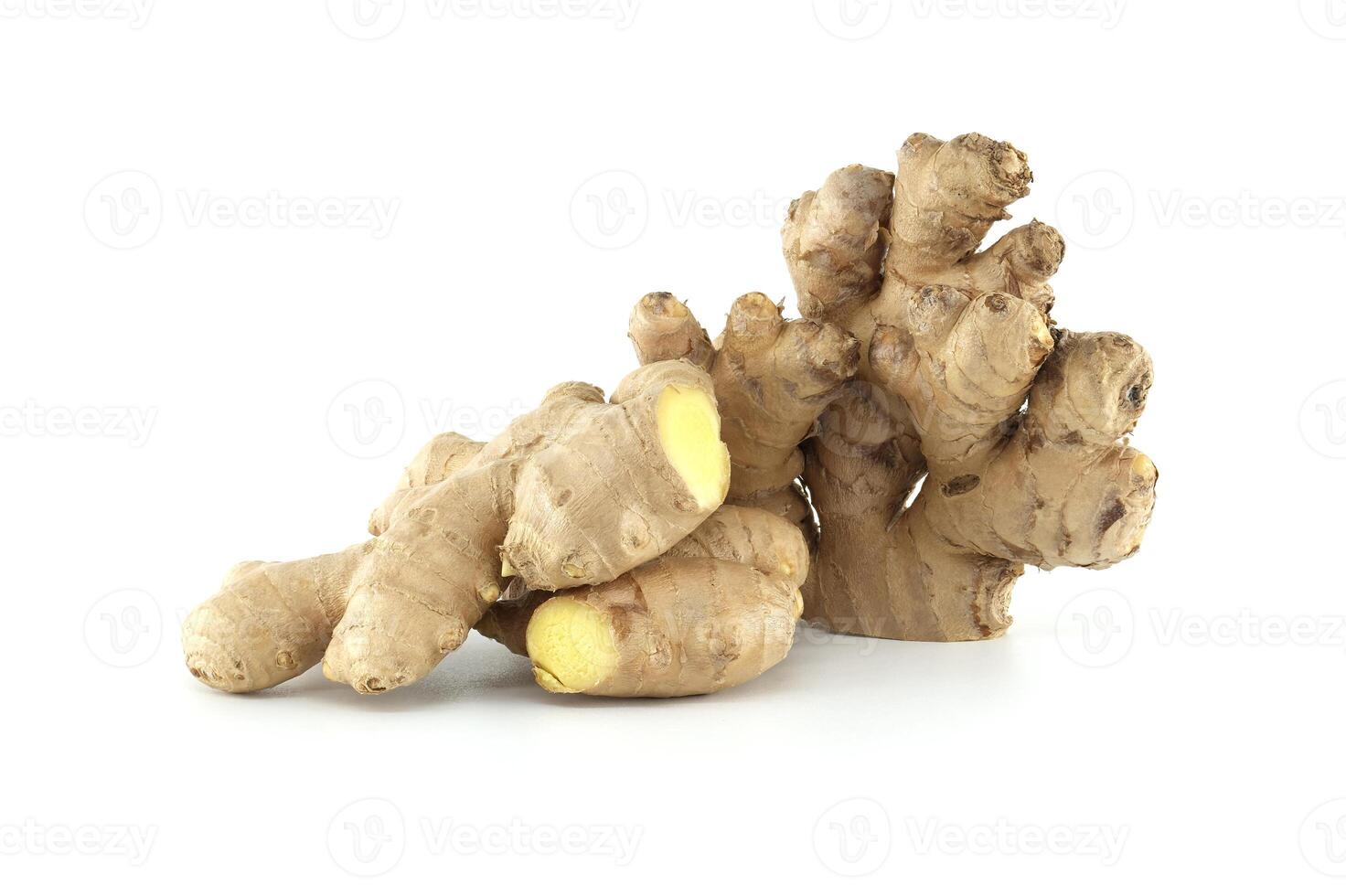 Fresh ginger root with a visible yellow inside lying on a white background photo