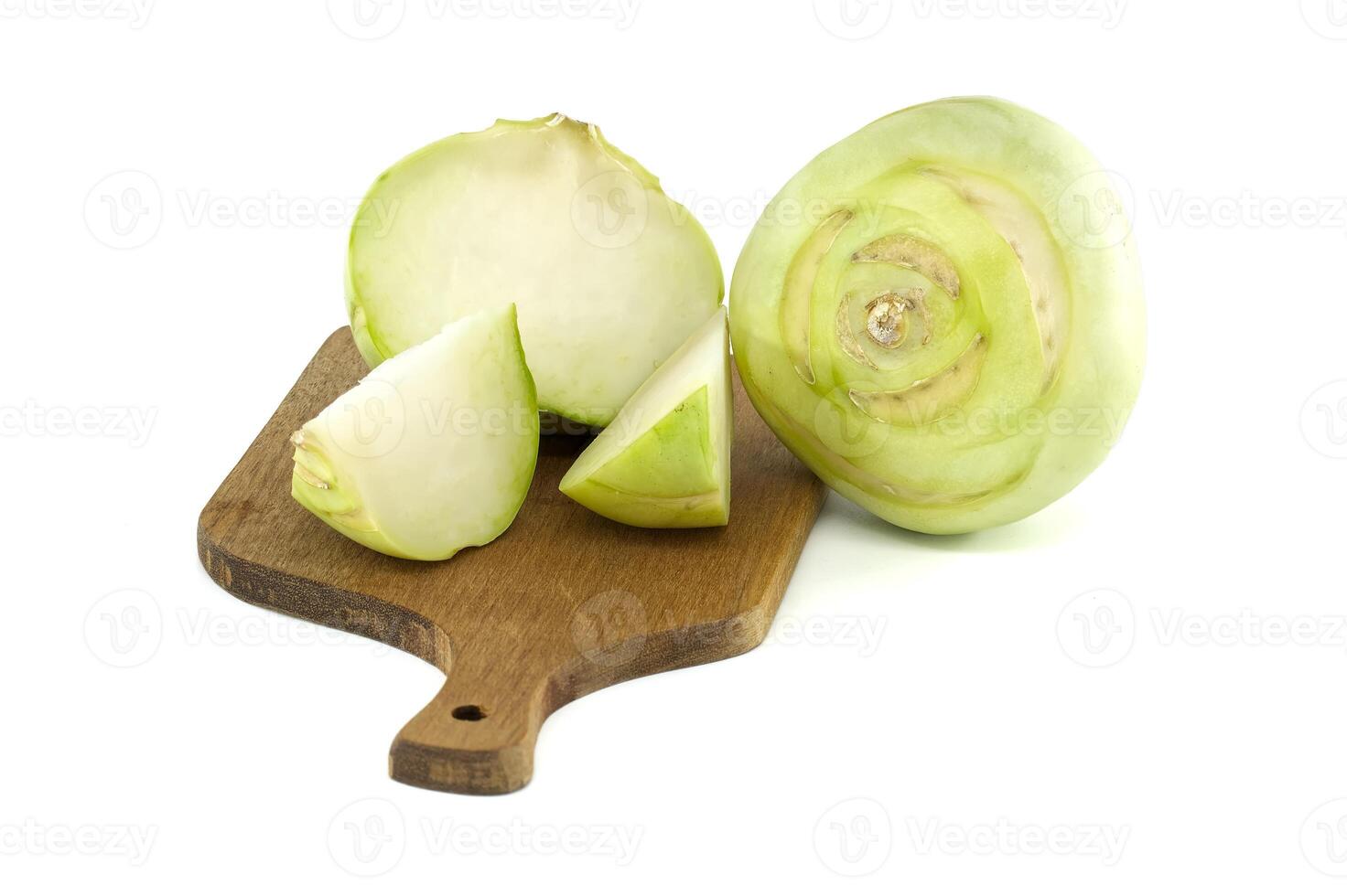 Fresh Kohlrabi Whole and Sliced on a Wooden Cutting Board. photo