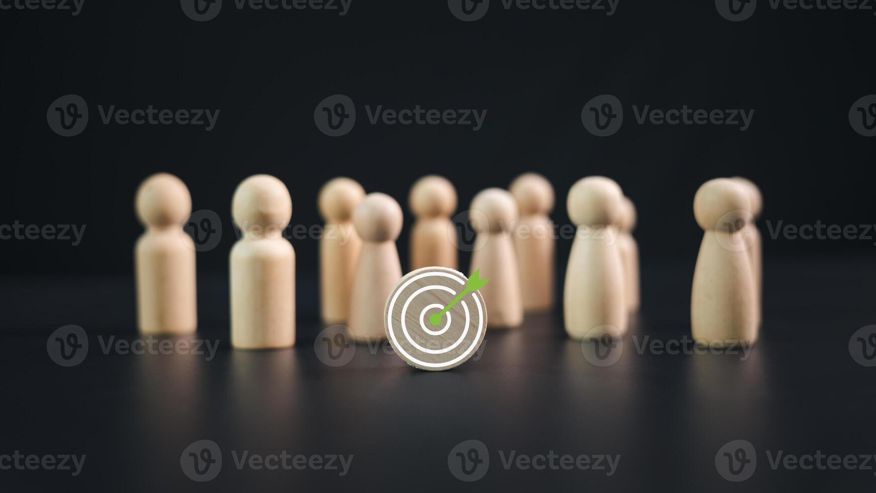 Team target concept of business and personnel in a company. Wooden dolls standing around Dart board and arrows for creating and targeting business objectives, Marketing solutions, Targets for business photo