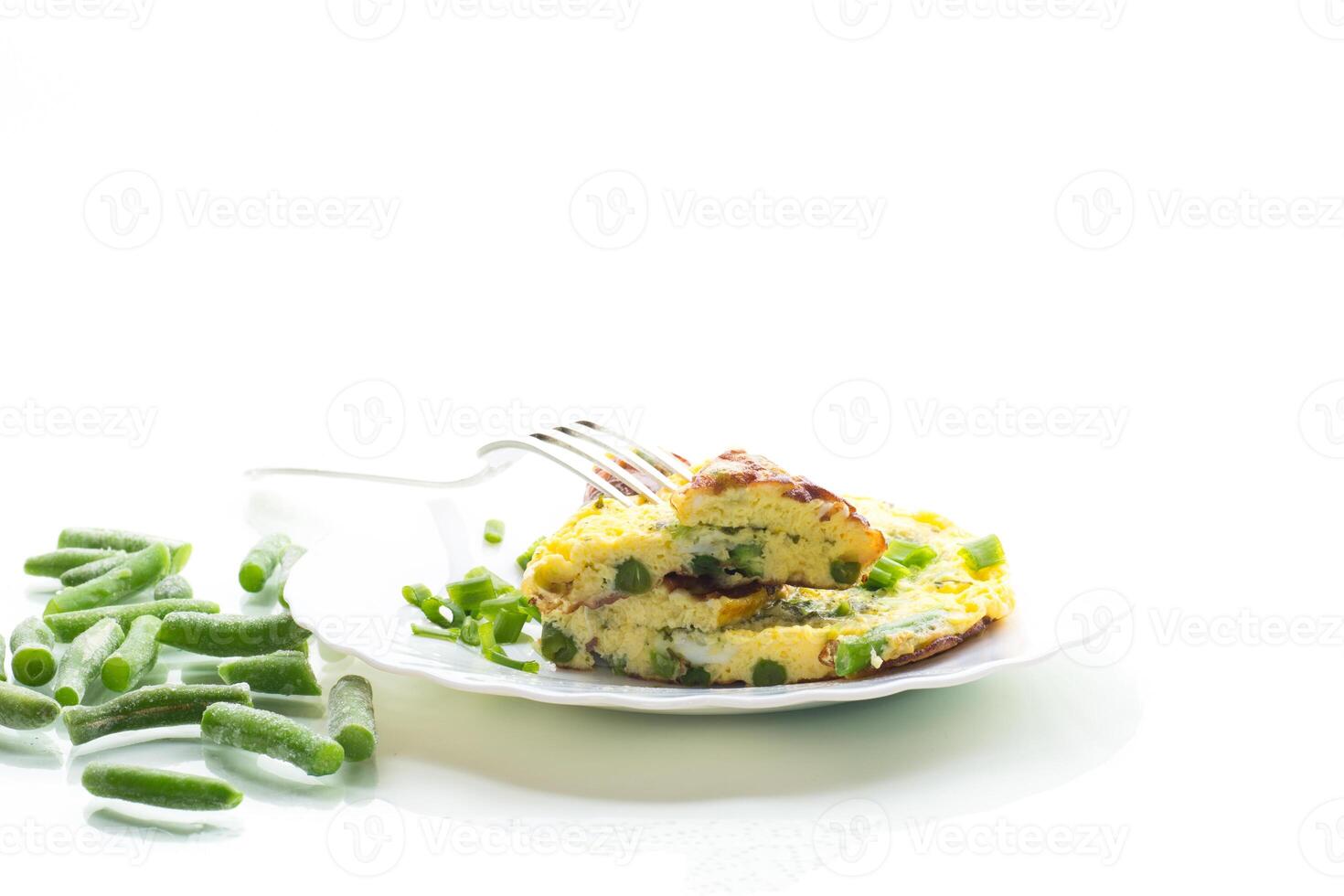 Egg omelette with herbs and vegetables isolated on white background photo