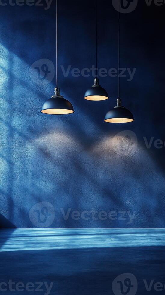 Three pendant lights casting soft illumination on a blue textured wall in a modern space photo