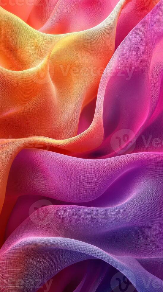 Vibrant silk fabric in shades of orange, pink, and purple drapes gracefully with flowing textures photo