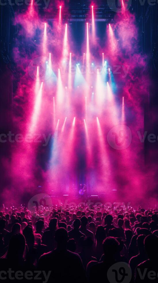 Crowd enjoys vibrant musical performance under colorful lights in concert hall photo