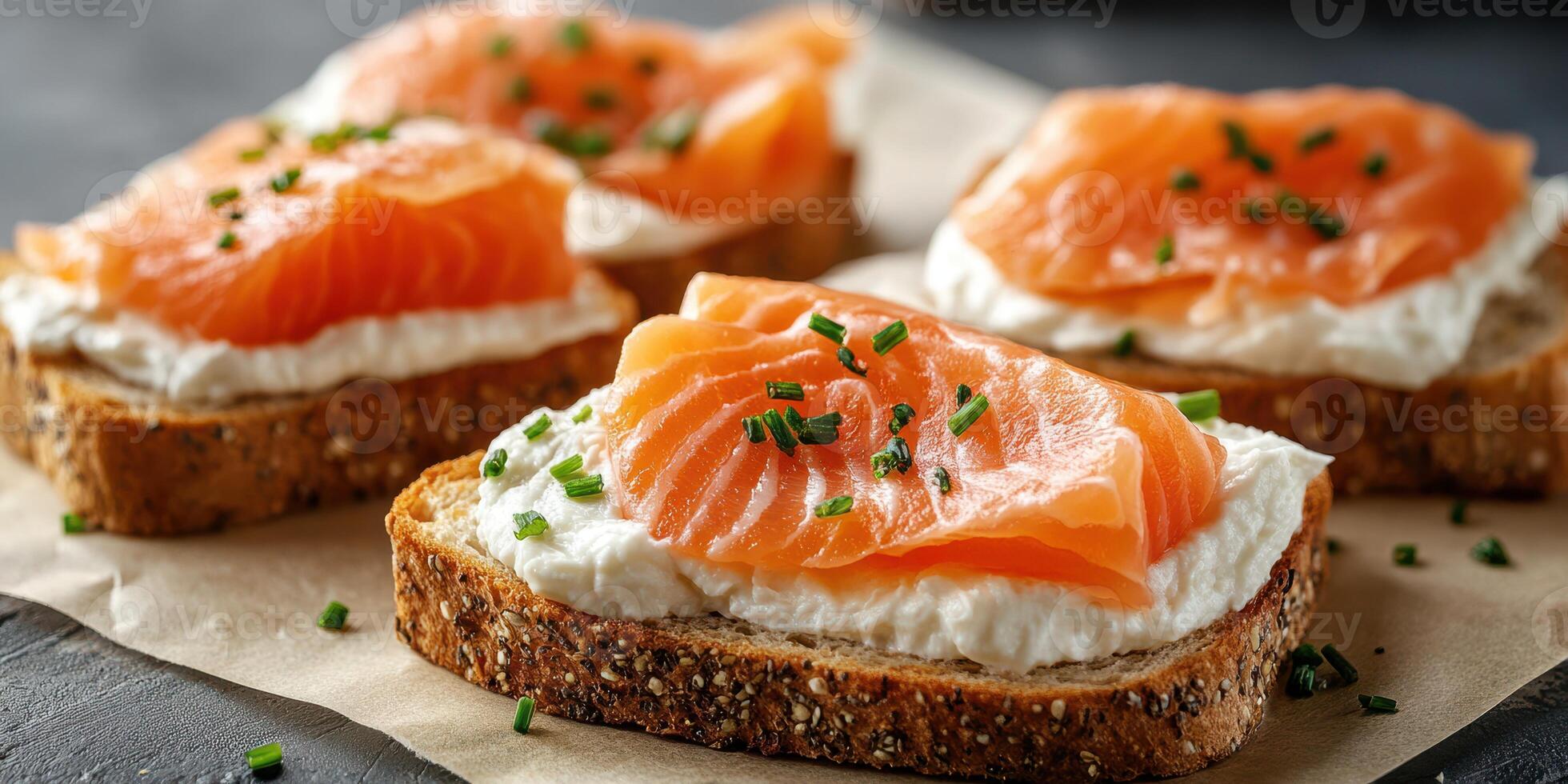 Delicious open-faced sandwiches with smoked salmon and cream cheese on whole grain bread photo