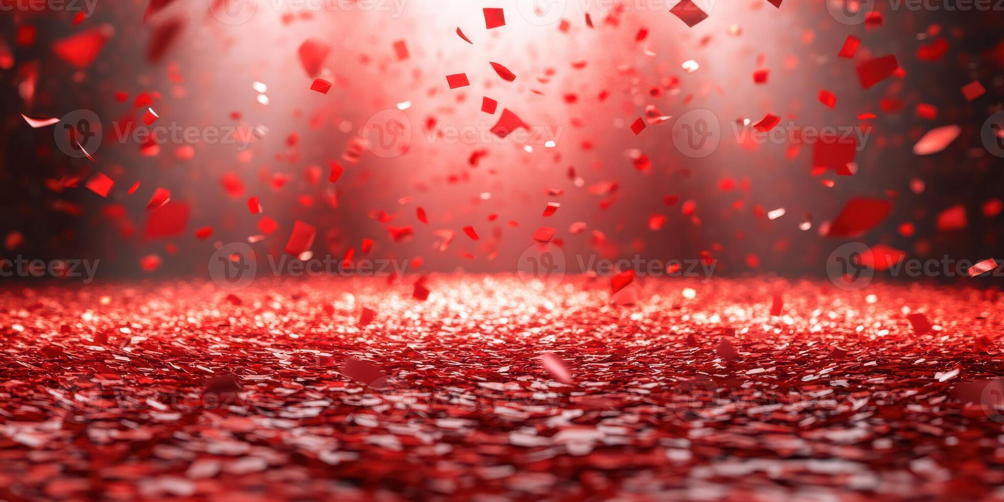 Red confetti falls gracefully on a bright stage during an exciting celebration or event photo