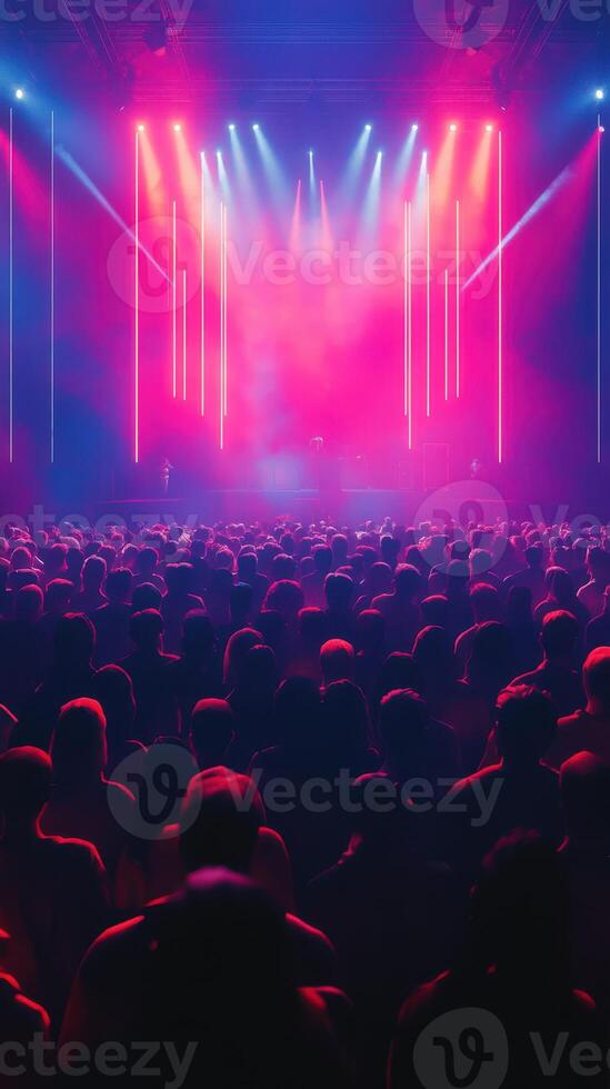Large audience enjoying vibrant concert lights at a music festival during the evening in a dynamic urban setting photo