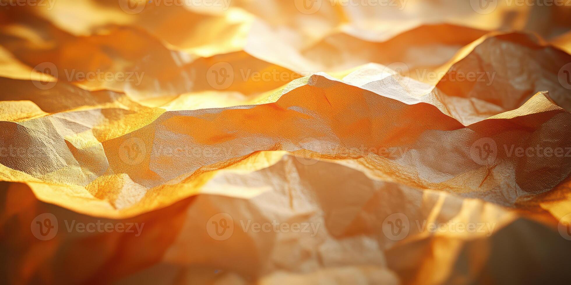 Textured orange paper with soft folds and gentle shadows under warm lighting photo