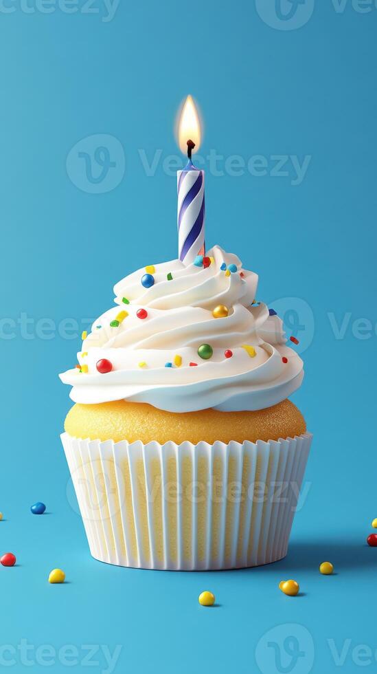 Decorated cupcake with sprinkles and a lit candle against a blue background photo