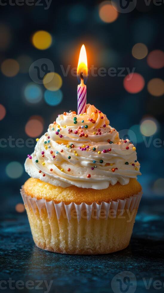 Colorful cupcake with candle glowing in a festive atmosphere during a celebration at night photo