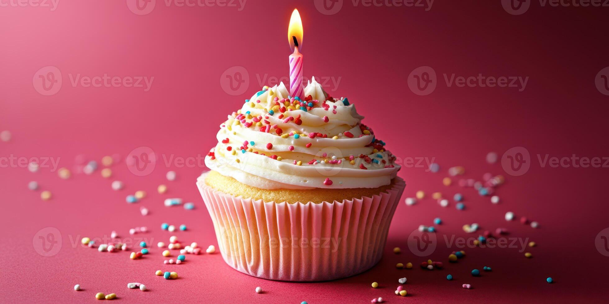 Colorful cupcake with a lit candle and sprinkles on a festive background for a birthday celebration photo