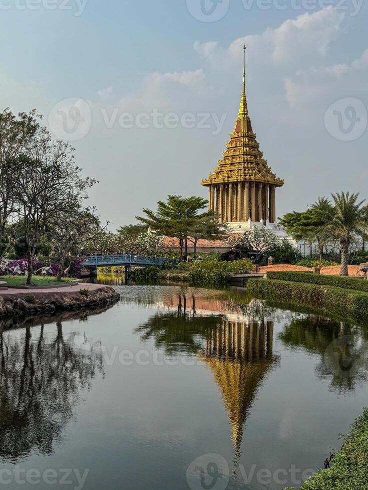 Golden temple stands majestically by the calm pond in a scenic landscape photo