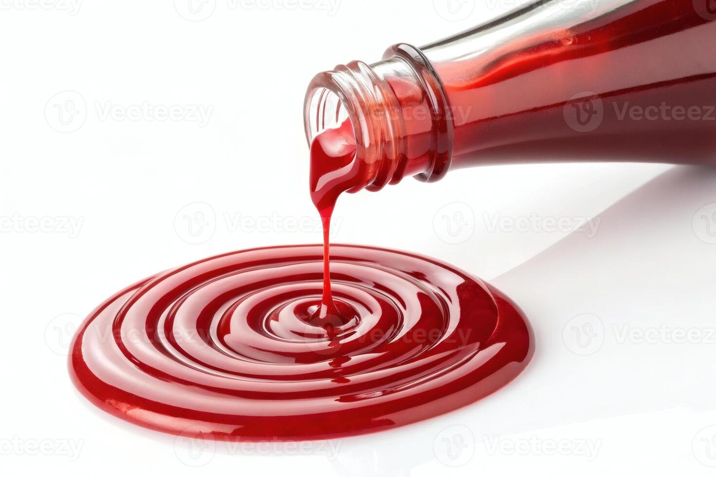 Pouring red syrup forming a spiral on white surface. photo