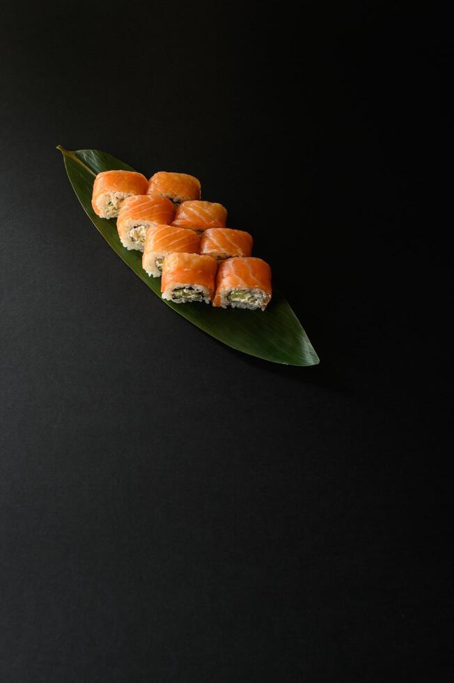 A classic Philadelphia roll with fresh salmon, creamy cheese, and seasoned sushi rice. Perfect for a Japanese menu, this visually appealing sushi is rich in flavor and beautifully presented. photo