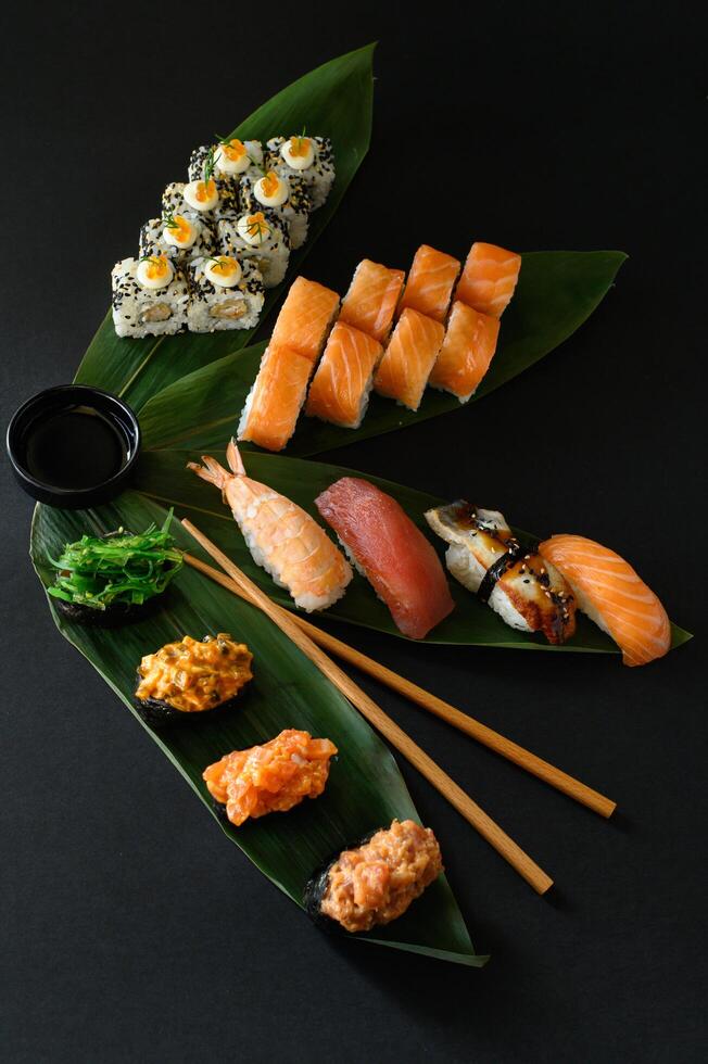 A vibrant sushi and roll set, perfect for a Japanese menu advertisement. Featuring fresh sashimi, classic rolls, and specialty sushi, beautifully arranged for an eye-catching presentation. photo