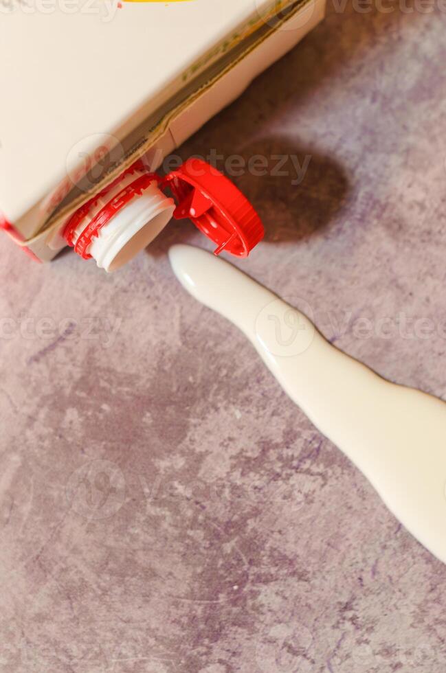 Milk spills from open carton, red cap, close-up. High quality photo