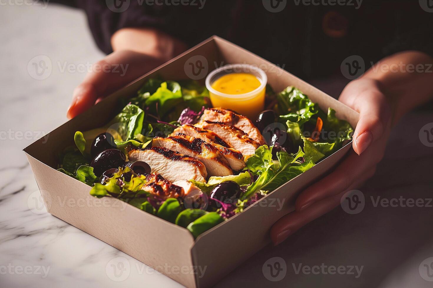A fresh grab-and-go salad with grilled chicken, lettuce, olives, and lemon dressing in an eco-friendly cardboard box. Perfect for a healthy lifestyle or quick lunch. . photo