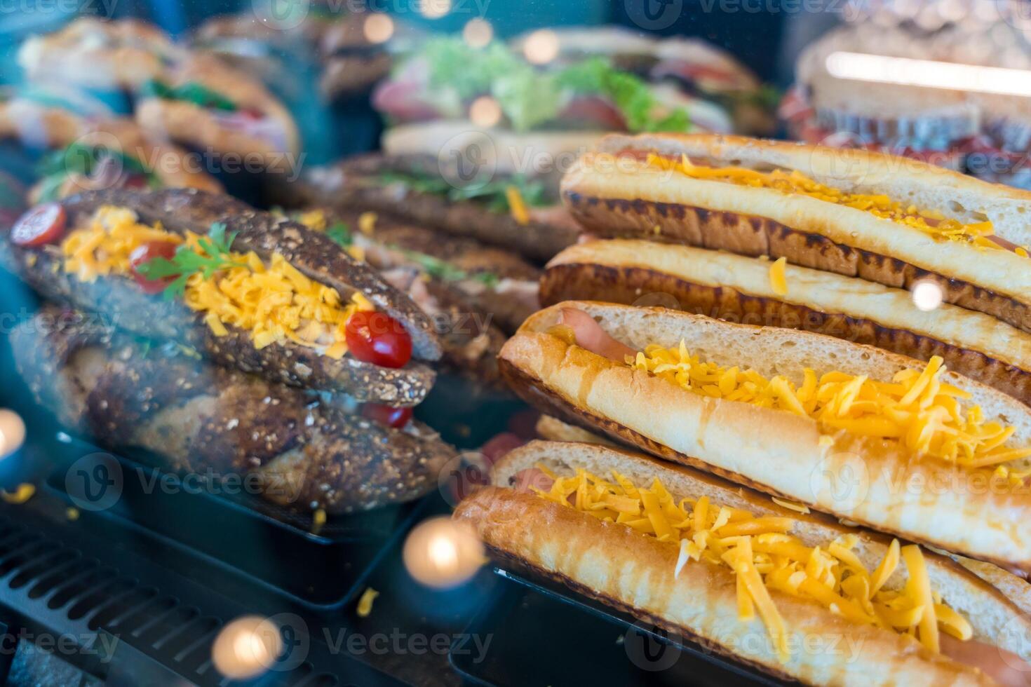 Fresh white and whole grain panini sandwich with cheddar cheese, cherry tomatoes in a bakery display photo