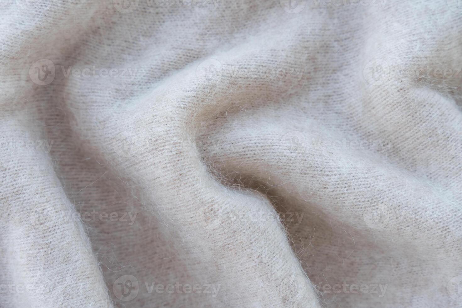 Close-up of soft white mohair fabric with delicate fibers and fluffy texture photo