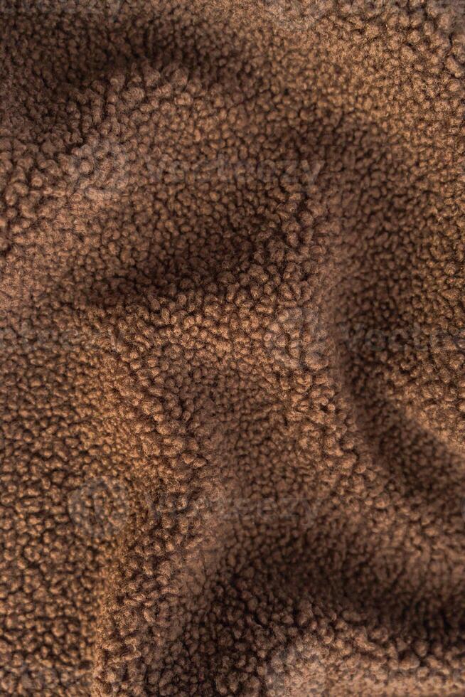 High-resolution macro shot of curly teddy recycled polyester fleece fabric. photo