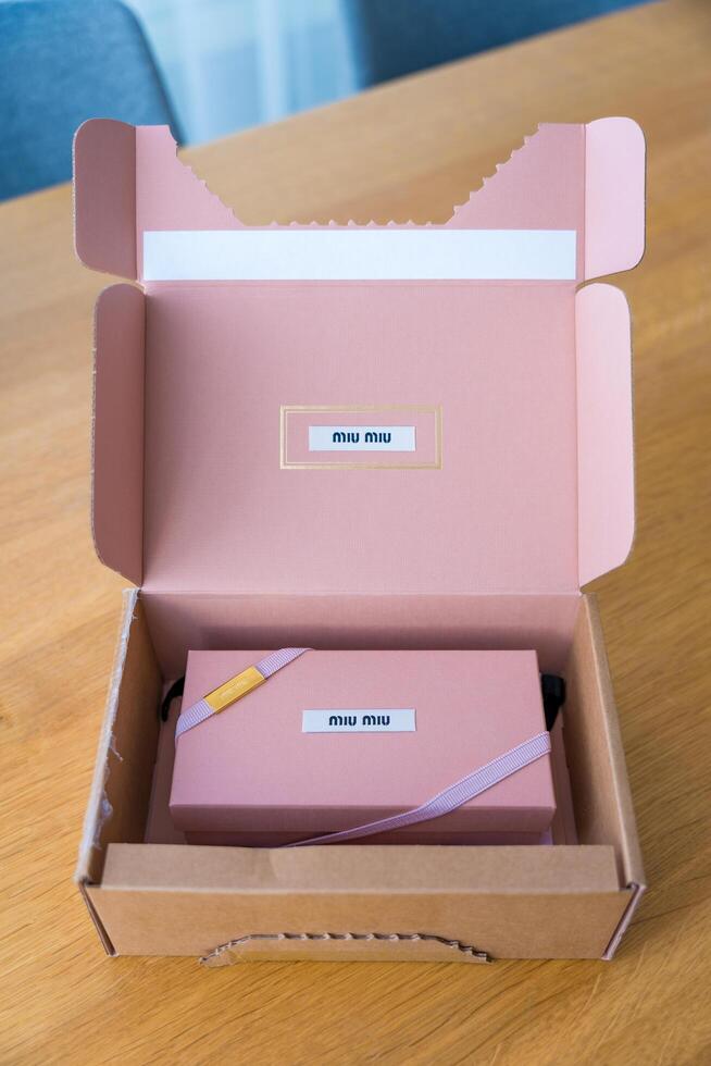 Prague, Czech republic - January 9, 2025. Miu Miu luxury sunglasses packaging in soft pink color photo