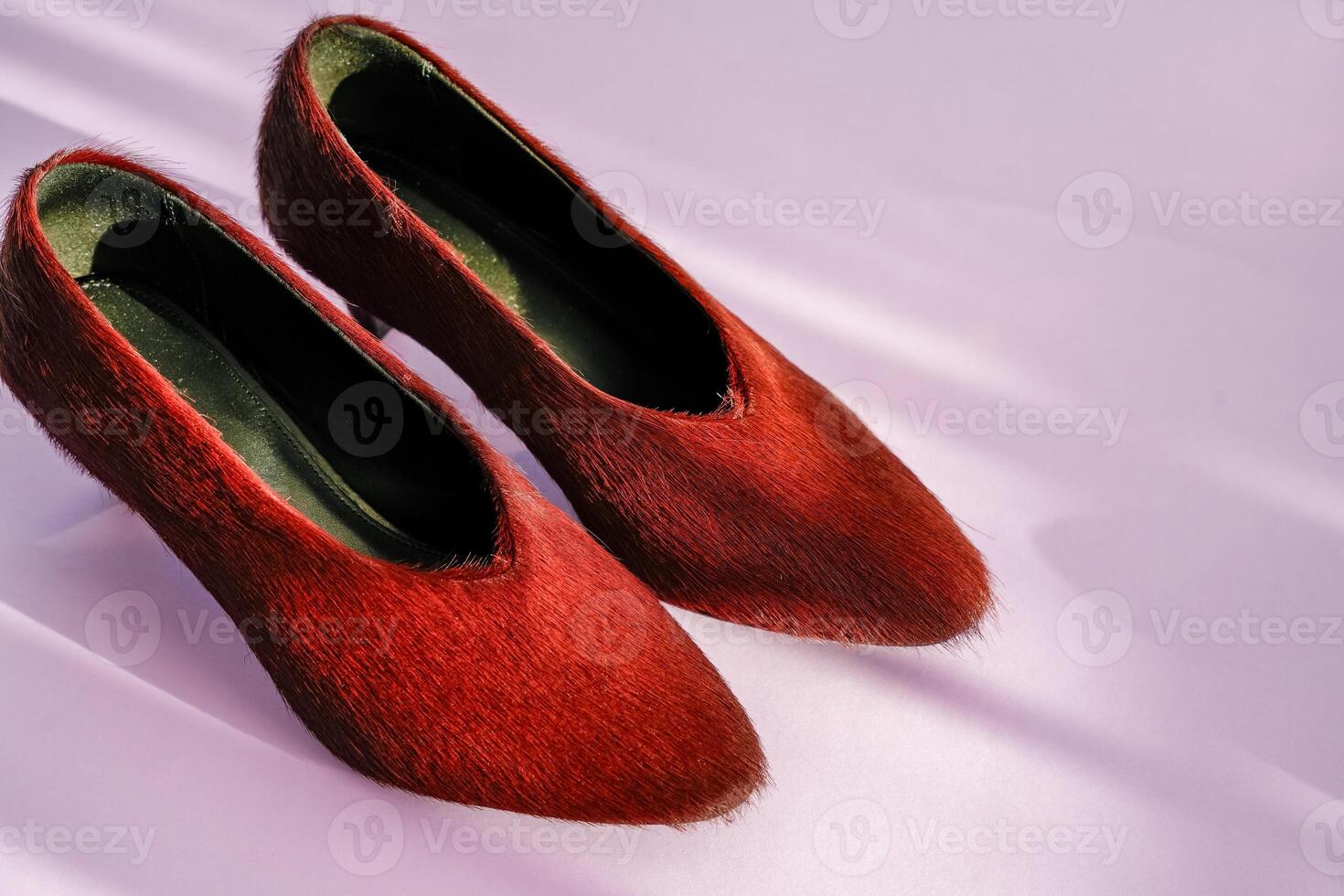 Burgundy textured leather pair with small heel, on purple background, fashion shoes photo