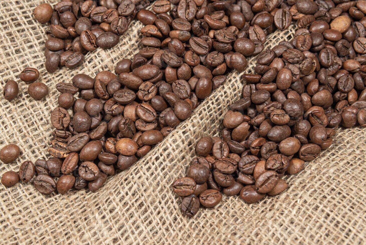 Blend of coffee beans on burlap fabric photo