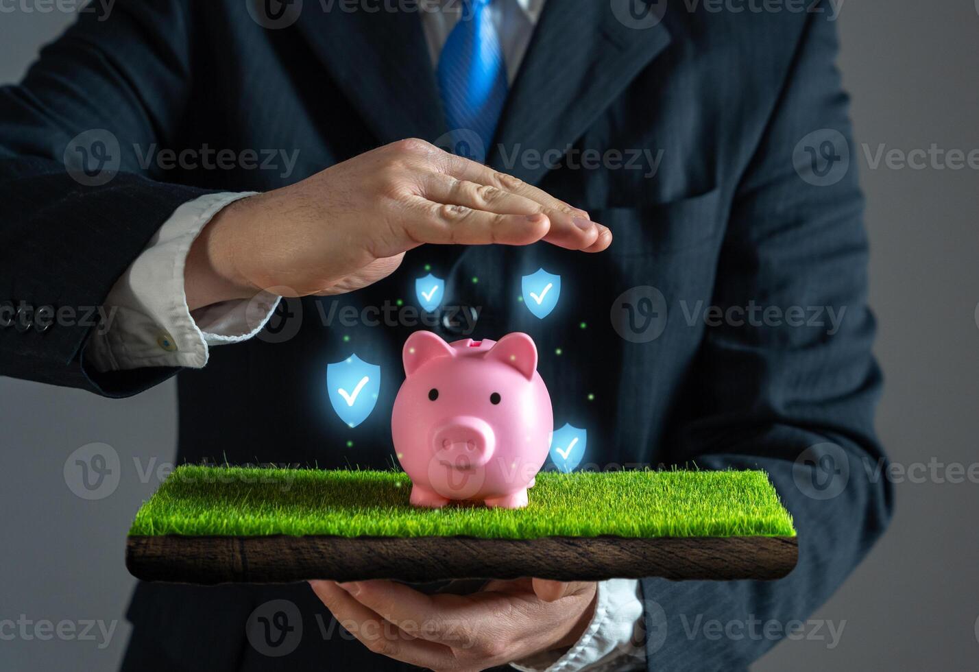 Businessman protects piggy bank with his hand. Concept of saving and guarantee of investments. Safeguarding funds. Financial stability. Protecting assets from risks. Financial security photo