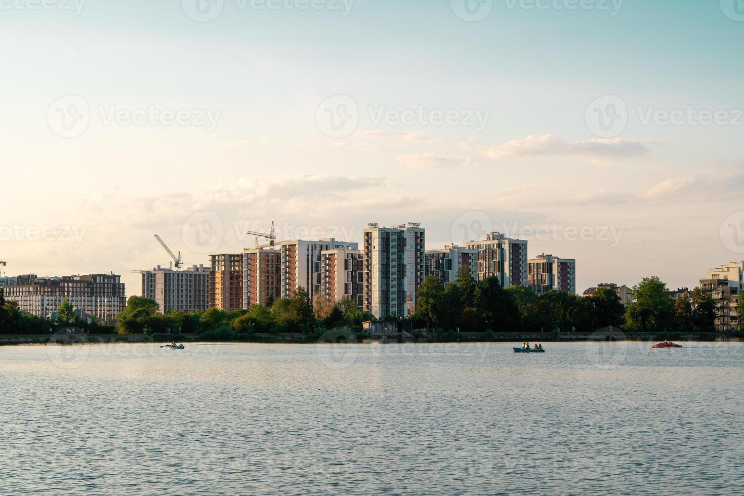 Beautiful view of the city lake with Multi-storey buildings with apartments. photo