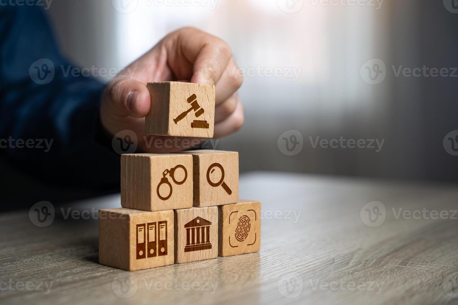 A man assembles a judicial system from blocks in the shape of a pyramid. Legal hierarchy, law enforcement, and justice system organization. photo