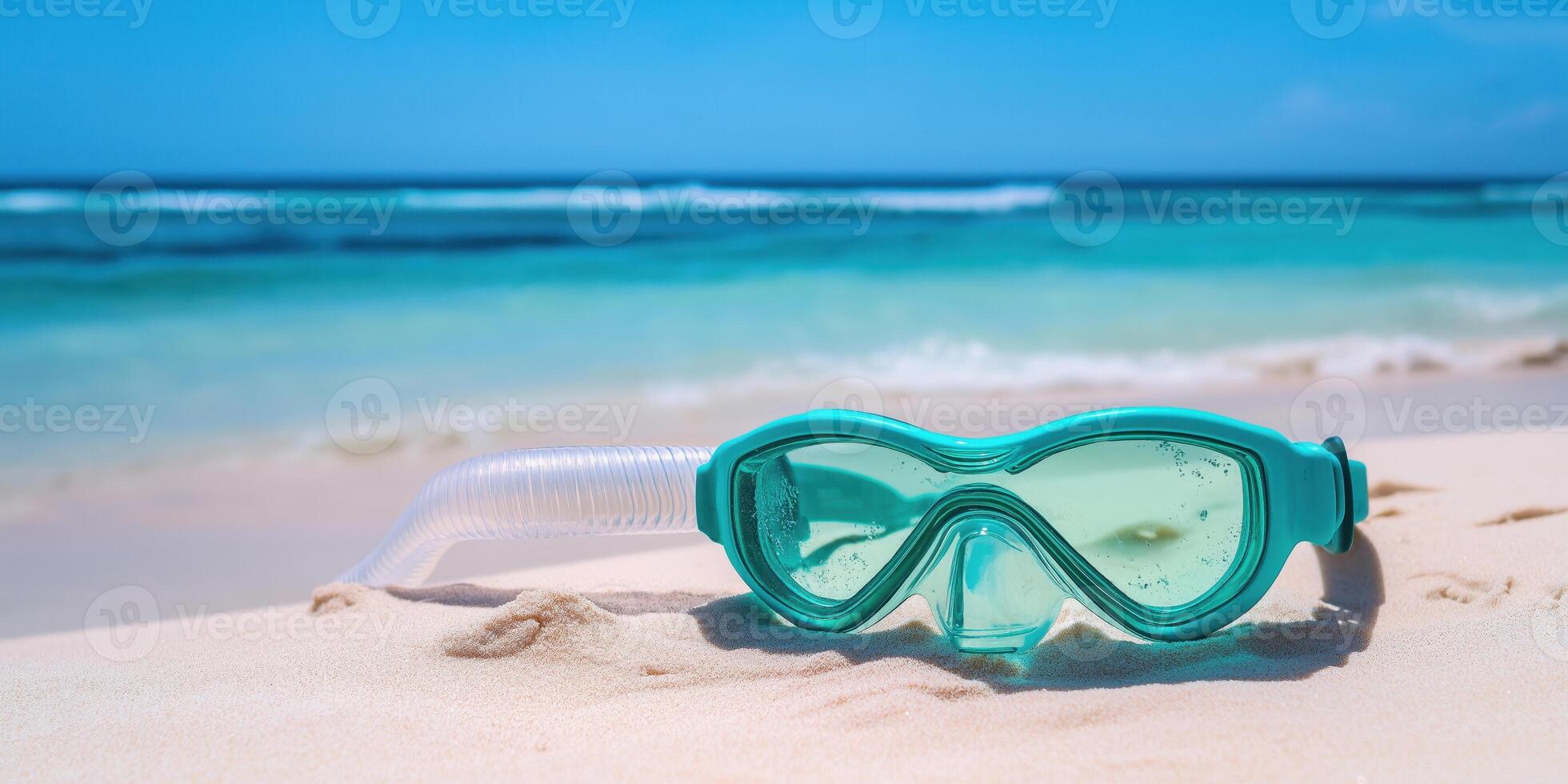 A pair of goggles and snorkel on the beach photo